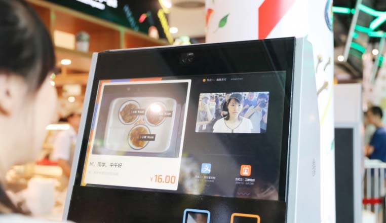 Chinese woman using a terminal to order food
